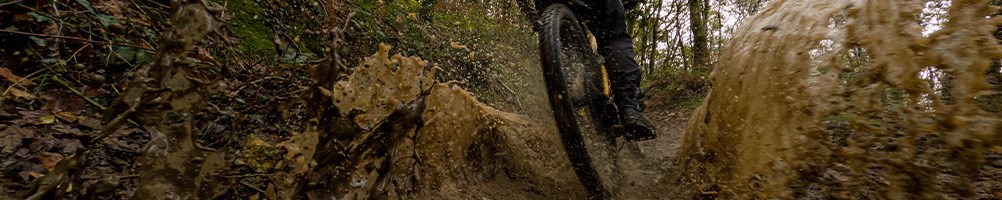 mountain biker riding through water